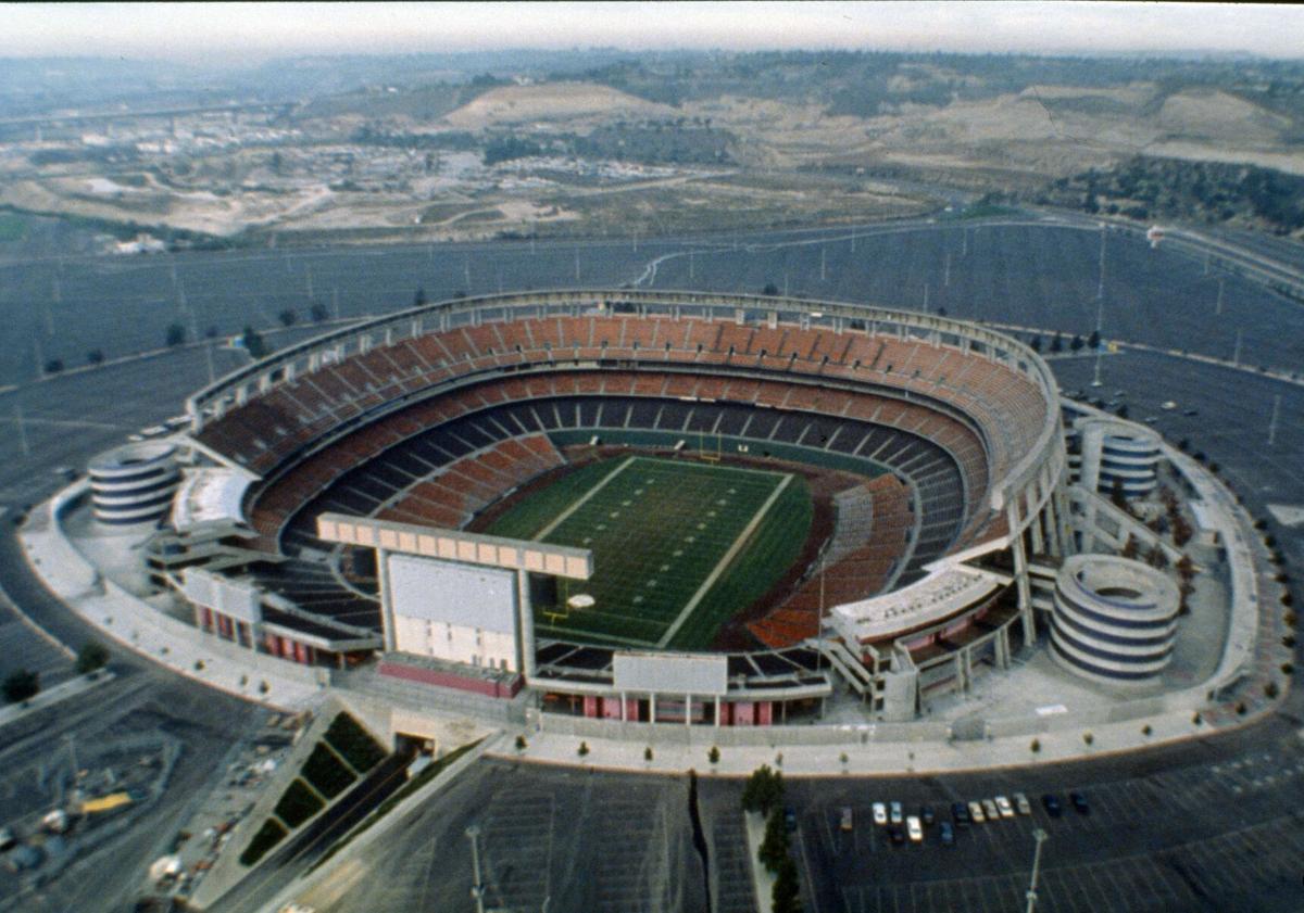 FILE - This 1987 file photo shows an aerial view of Jack Murphy Stadium in San Diego, Calif., site of Super Bowl XXII. Now the stadium is coming to an unceremonious end, leaving generations of fans feeling melancholy because, due to the coronavirus pandemic, they didn't get to say a proper goodbye to the place where they tailgated with gusto in the massive parking lot before cheering on the Chargers, Padres and Aztecs, or watched myriad other events and concerts. (AP Photo/File)